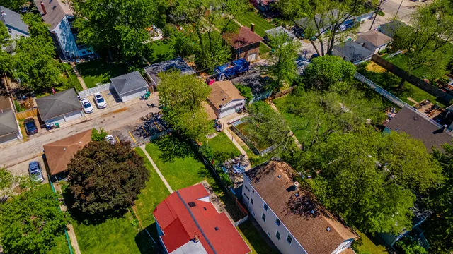 an aerial view of a house with a yard