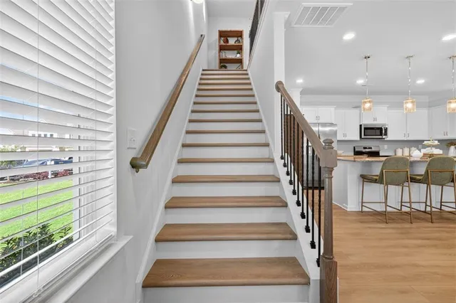 a view of entryway and hall with wooden floor