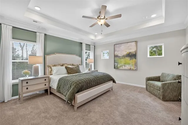 a spacious bedroom with a bed a couch and a window