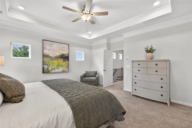 a bedroom with a bed a dresser and a painting