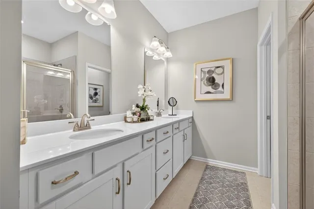 a spacious bathroom with a double vanity sink and a mirror