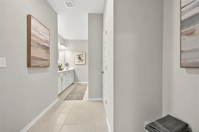 a view of a hallway with wooden floor and a living room