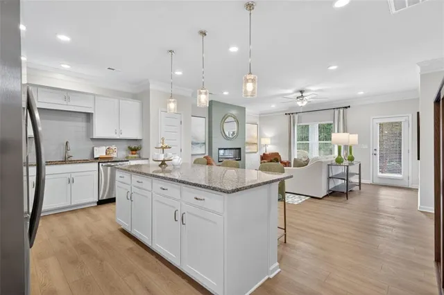 a large kitchen with lots of counter space a sink appliances and cabinets