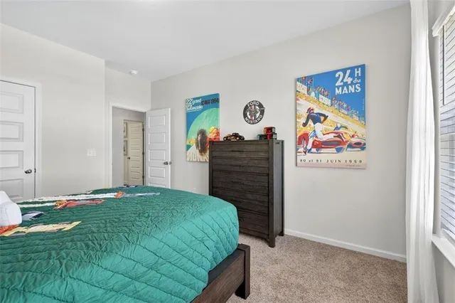 a bedroom with a bed and painting on the wall