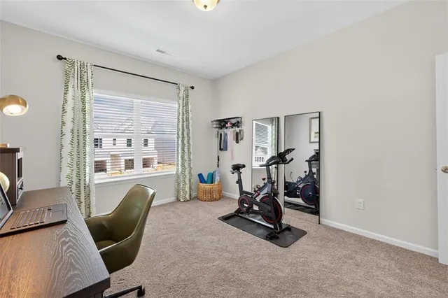 a view of a livingroom with lounge chair and windows