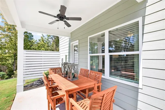 a view of a patio with a dining table and chairs