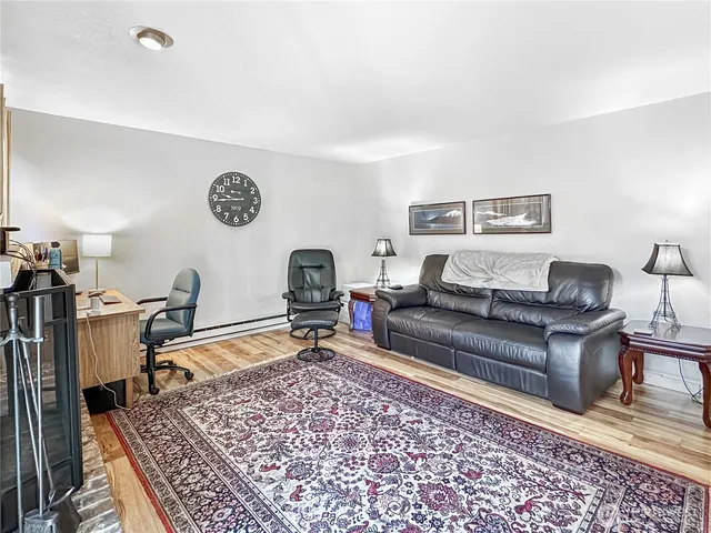 a view of a dining room with furniture wooden floor and a chandelier