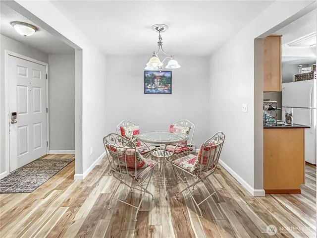 a view of a dining room with furniture and chandelier