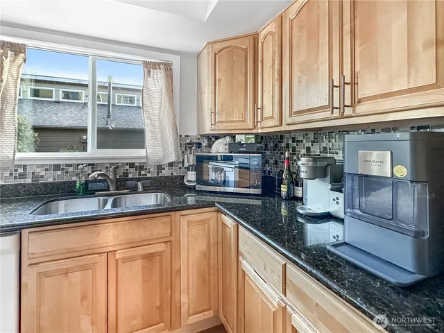 a kitchen with granite countertop a sink and a window