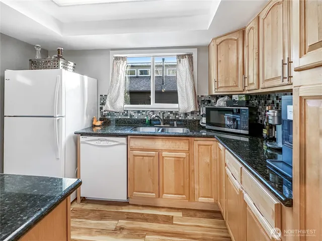 a kitchen with a stove a refrigerator and cabinets