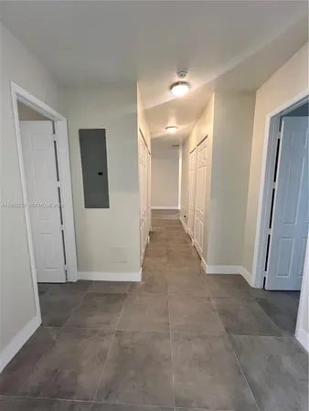 a view of a hallway with wooden shelves