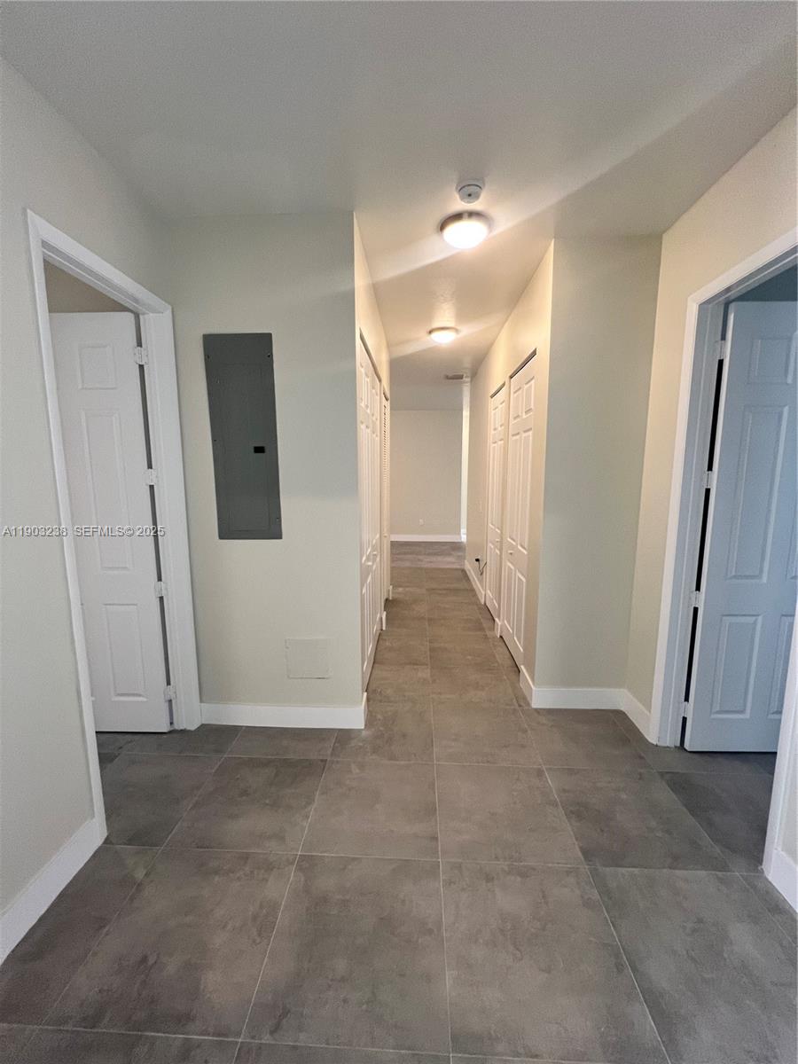 10274 Southwest 180th Street, Unit 1 Miami, FL 33157 - Photo 16 of 17 a view of a hallway with wooden shelves