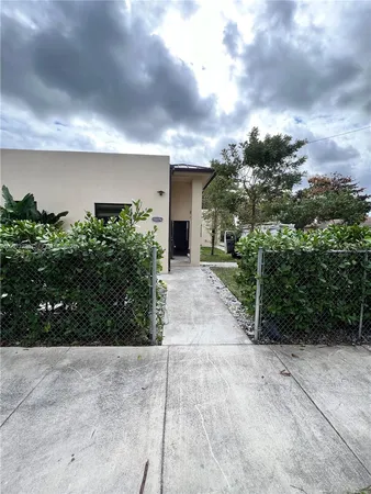 a view of a yard with potted plants