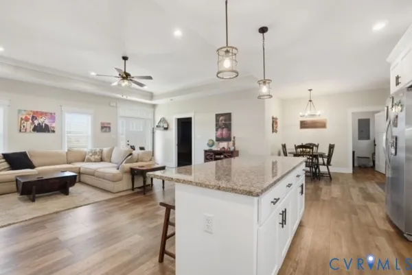 a large living room with furniture and a wooden floor