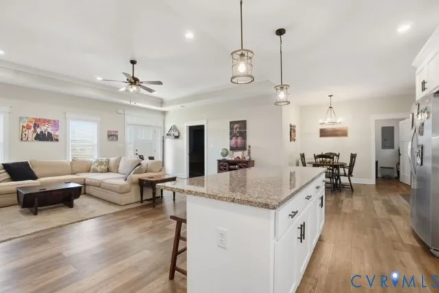 a large living room with furniture and a wooden floor
