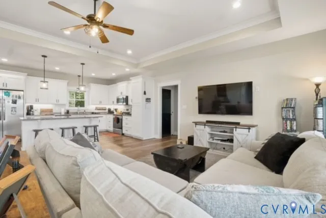 a living room with furniture and kitchen view