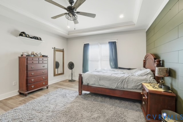 15305 Keelers Mill Road Dewitt, VA 23840 - Photo 20 of 38 a bedroom with a bed and a chandelier