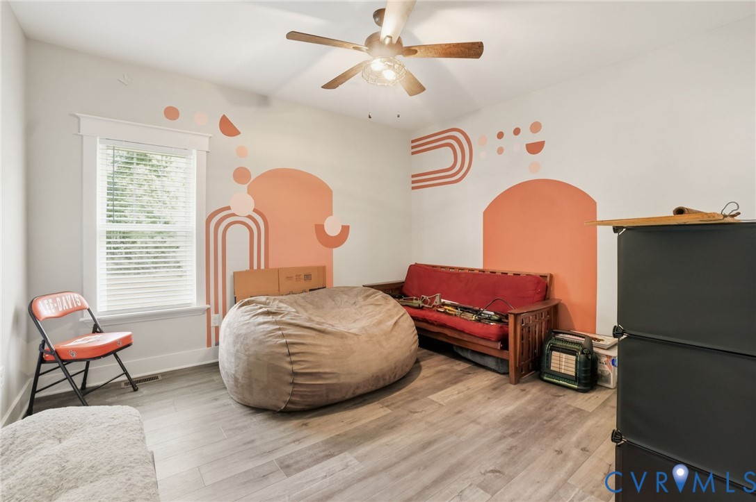 15305 Keelers Mill Road Dewitt, VA 23840 - Photo 25 of 38 a bedroom with a bed and a chandelier