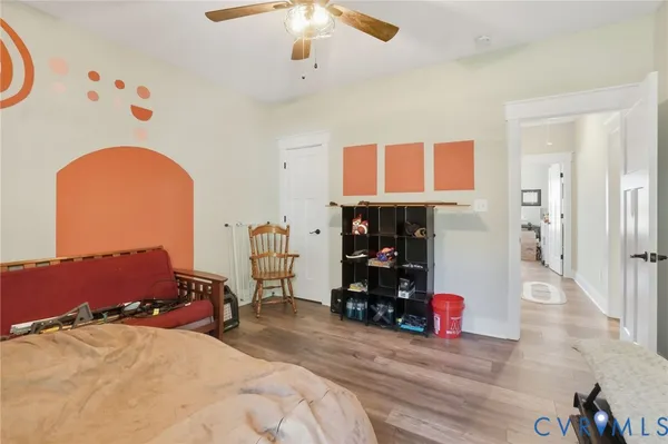 a bedroom with bed and a chandelier