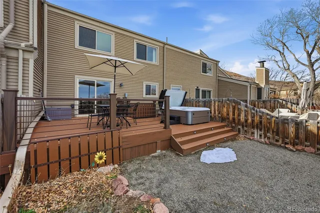 a view of a house with wooden floor and outdoor seating