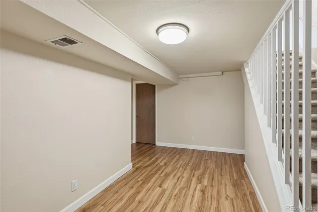 a view of a room with wooden floor and stairs