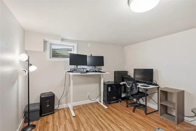 a view of a workspace with furniture and a window