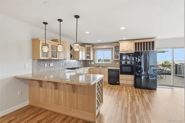 a large kitchen with stainless steel appliances granite countertop a large center island attached withe living room