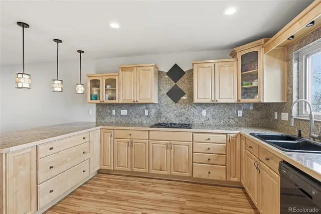 a kitchen with granite countertop a sink and cabinets