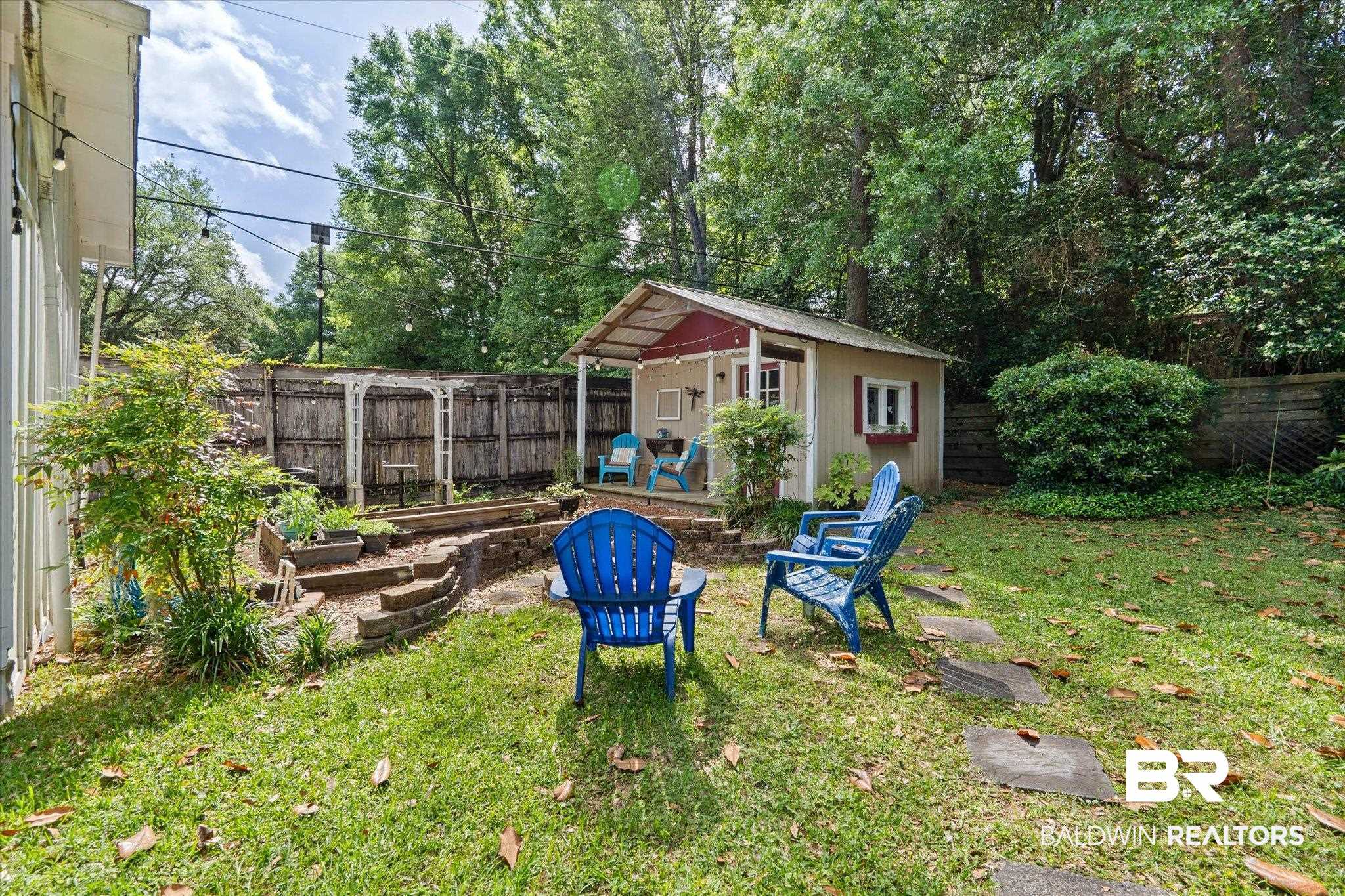 559 East Cumberland Road Mobile, AL 36608 - Photo 35 of 48 Fenced backyard with an outdoor structure, a patio, and a vegetable garden