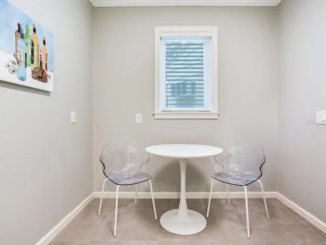 a dining room with furniture and a window
