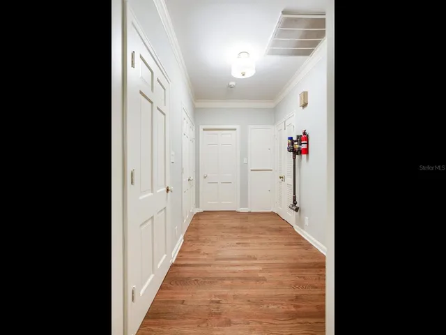 a spacious bedroom with a bed and a chandelier