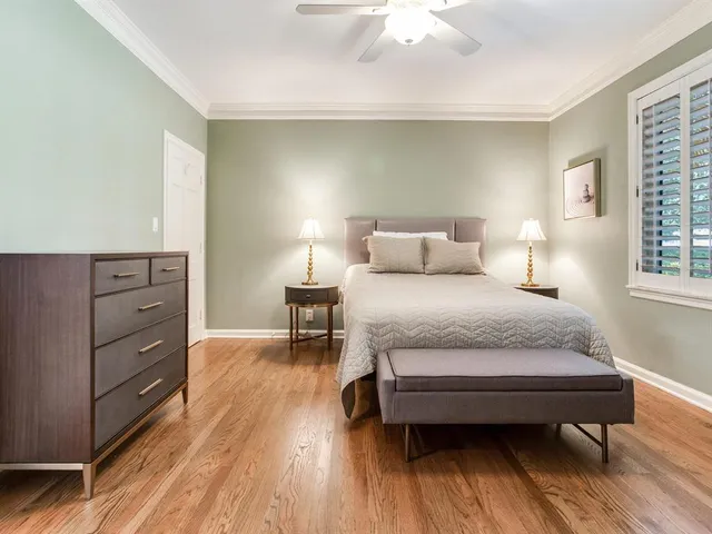 a bathroom with a toilet sink vanity and mirror