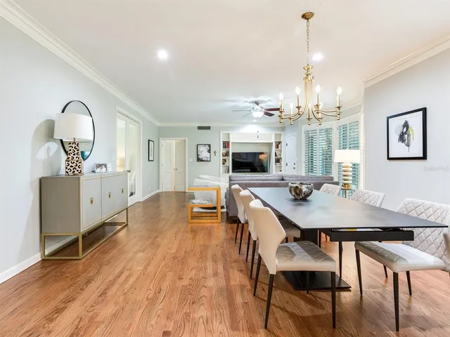 a view of a dining room with furniture and chandelier