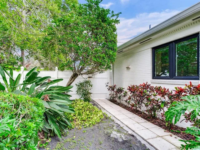 a view of a grassy field with trees