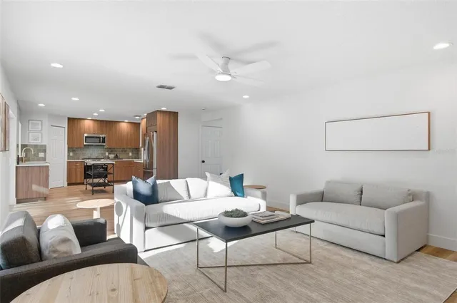 a kitchen with a refrigerator and wooden cabinets
