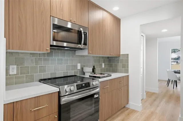 a kitchen with a dining table chairs refrigerator and cabinets