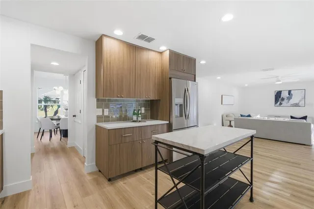 a kitchen with a sink and a stove top oven