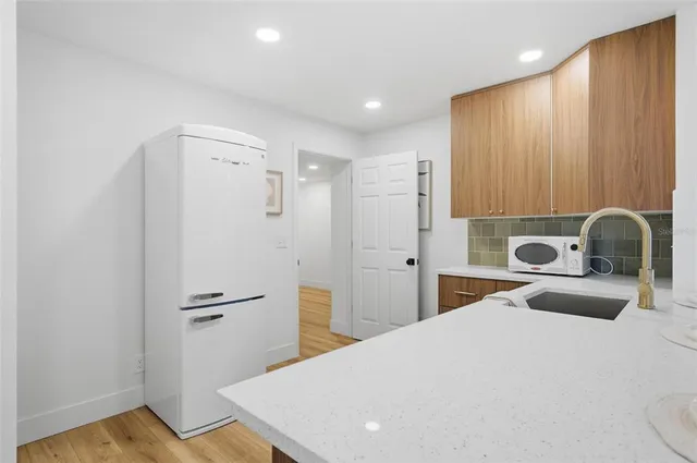 a kitchen with a sink and cabinets
