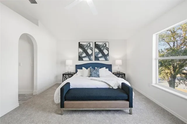 a bedroom with a bed and a lamp