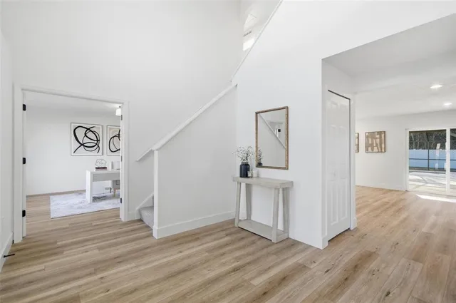 a view of empty room with wooden floor