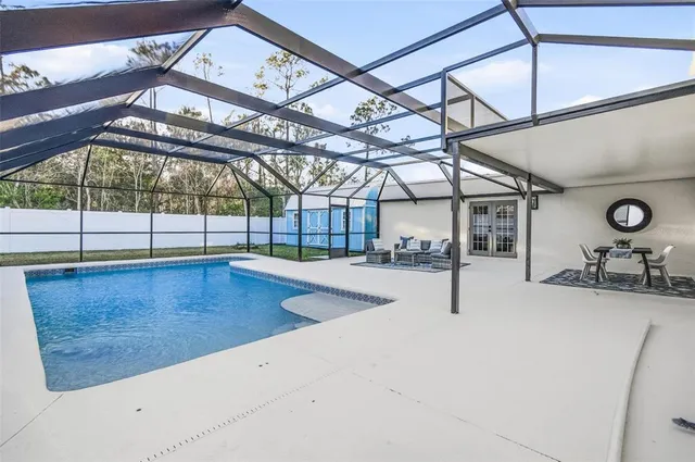 a view of a house with a backyard