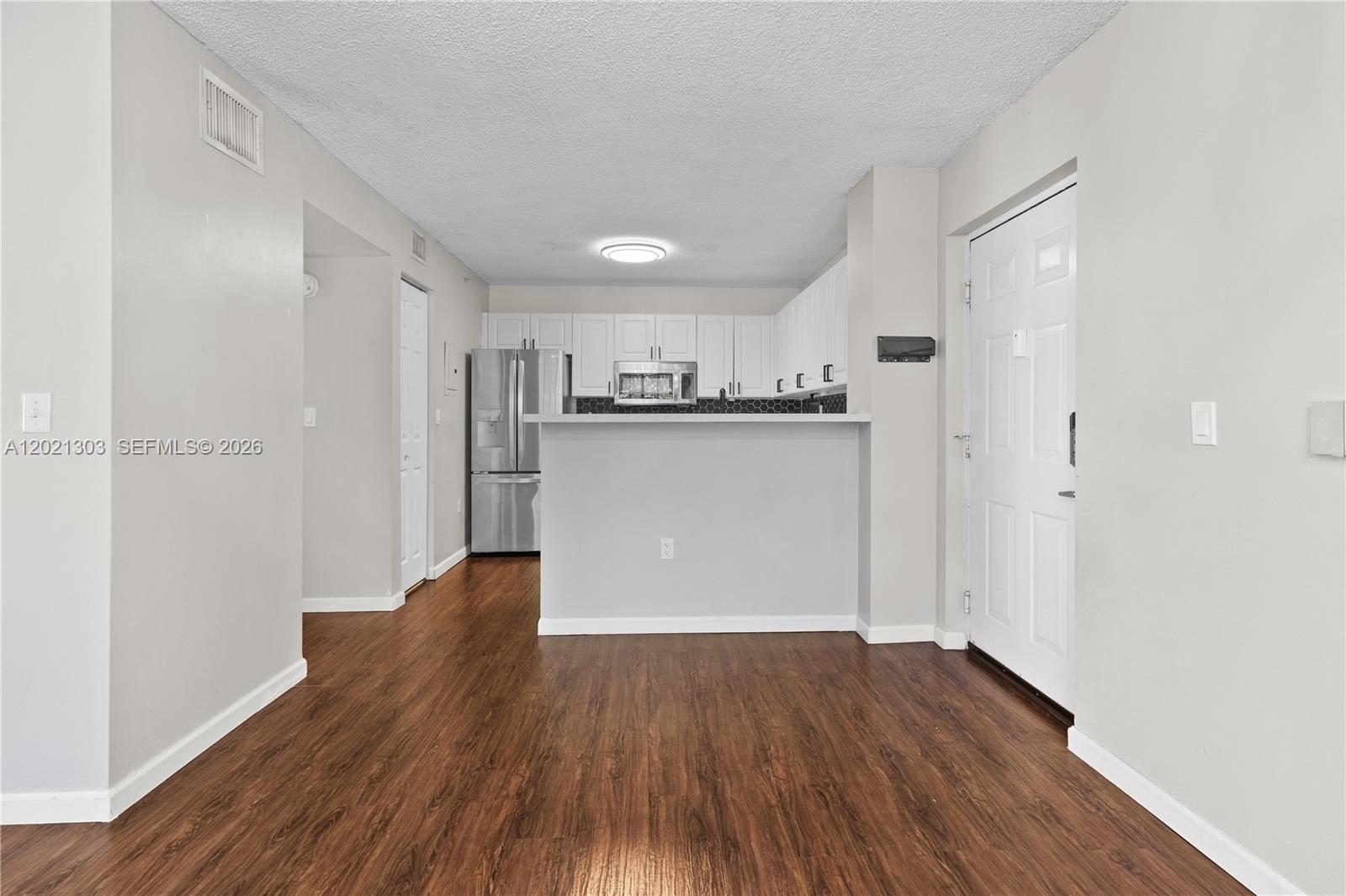 2123 Renaissance Boulevard, Unit 201 Miramar, FL 33025 - Photo 8 of 22 a view of a kitchen with wooden floor
