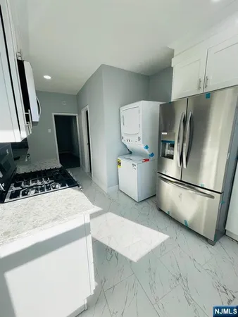 a kitchen with stainless steel appliances a refrigerator sink and stove