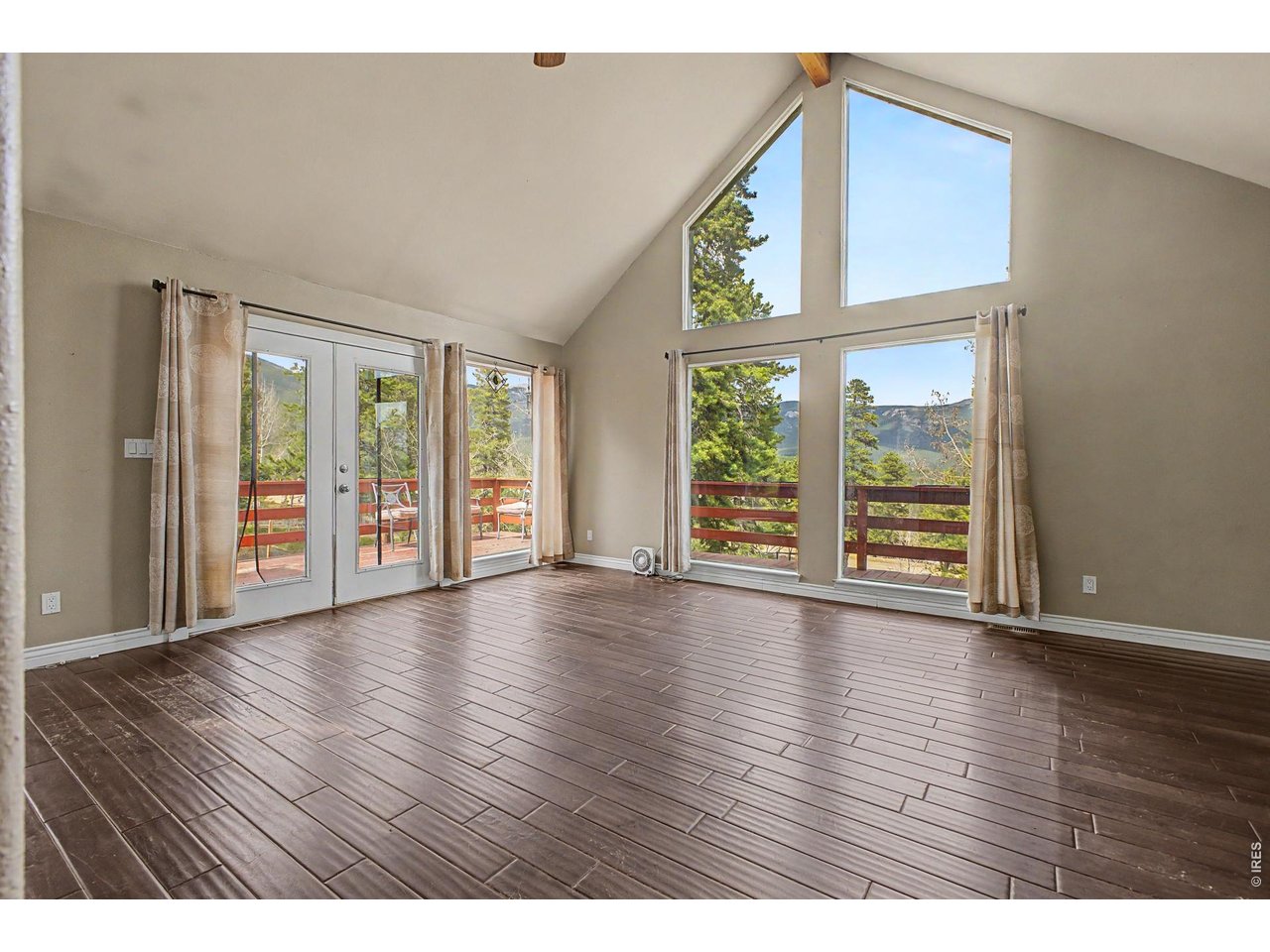 76 Highlands Drive Bailey, CO 80421 - Photo 17 of 49 a view of an empty room with wooden floor and a window