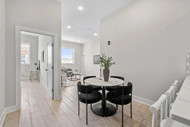a view of a dining room with furniture and wooden floor