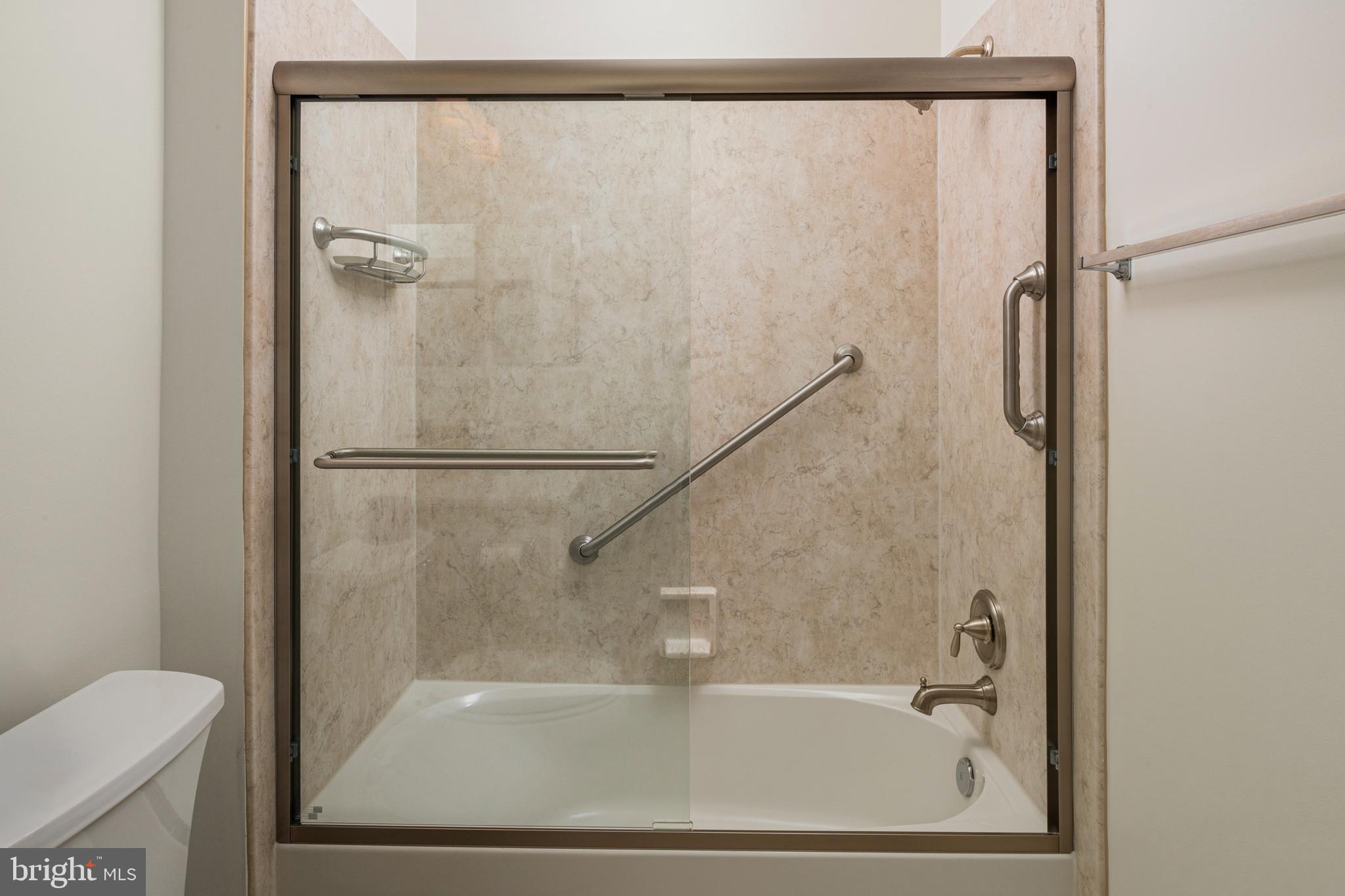 8601 Roaming Ridge Way, Unit 304 Odenton, MD 21113 - Photo 24 of 40 a bathroom with a bathtub and a shower