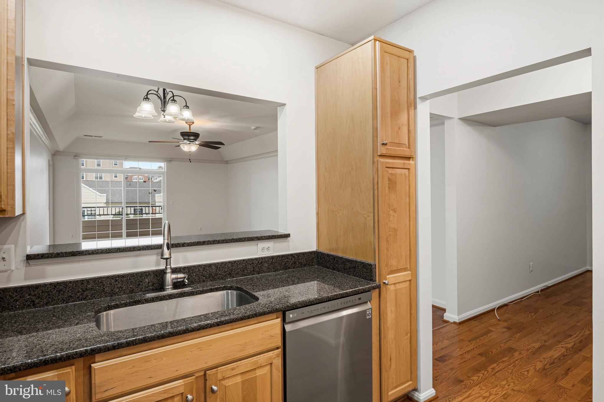 8601 Roaming Ridge Way, Unit 304 Odenton, MD 21113 - Photo 4 of 40 a bathroom with a granite countertop sink and a mirror