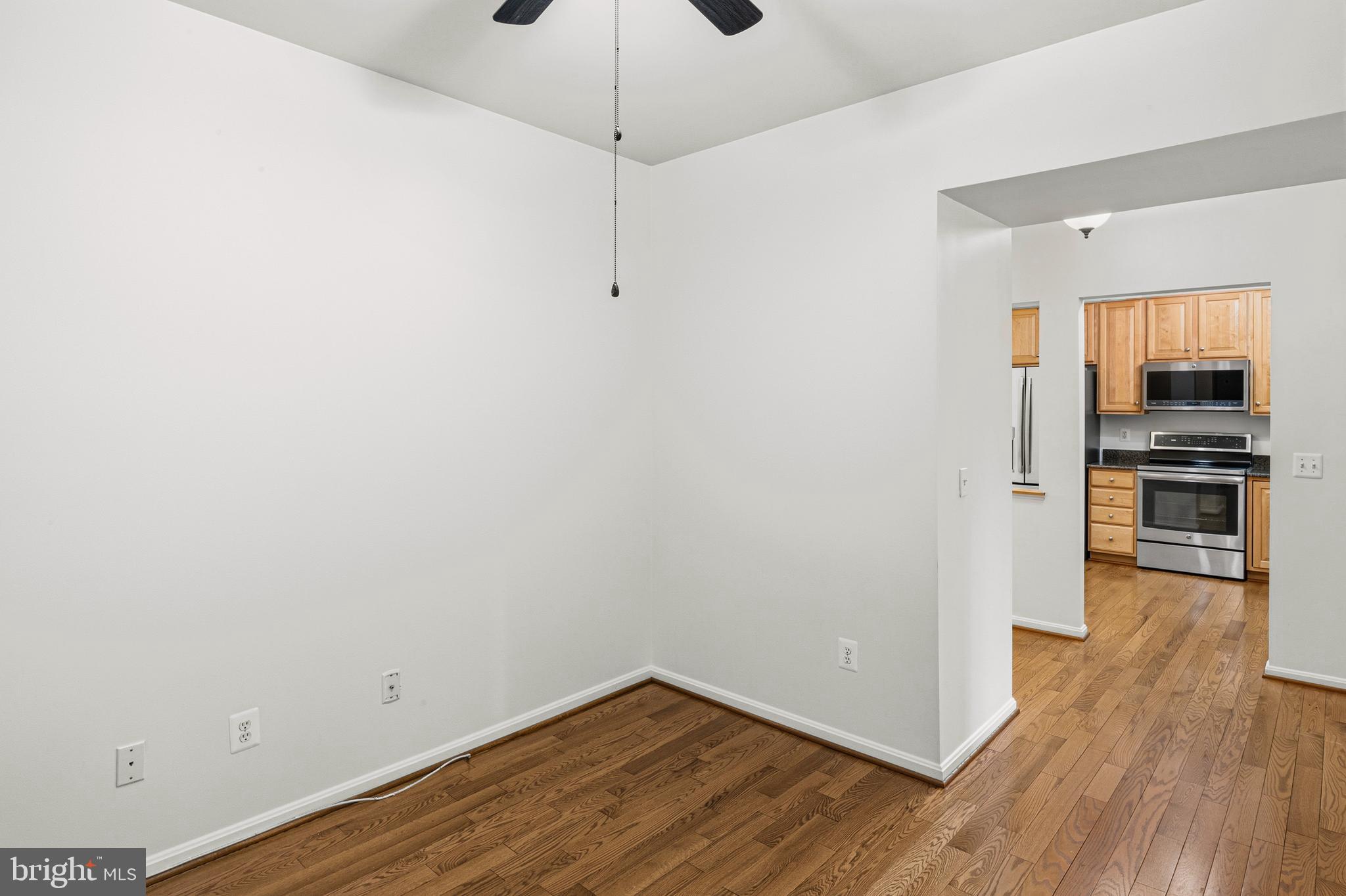 8601 Roaming Ridge Way, Unit 304 Odenton, MD 21113 - Photo 10 of 40 a view of a kitchen with wooden floor and a sink
