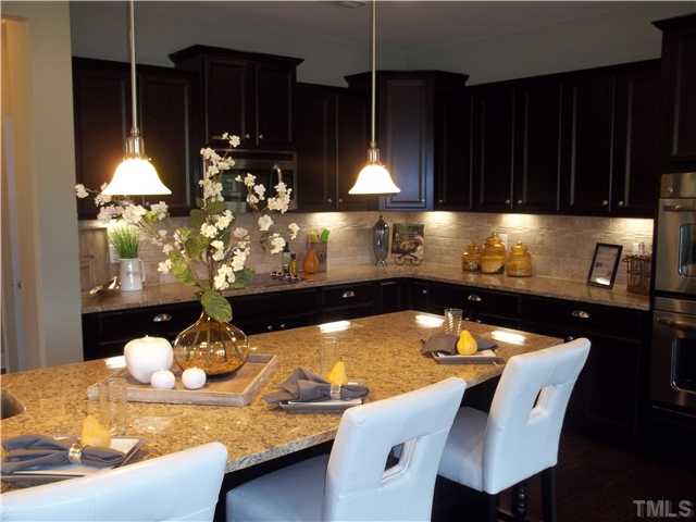 2201 Lower Lake Road Wake Forest, NC 27587 - Photo 4 of 25 Our beautiful oversized Kit Island is GREAT for anyone who loves the kitchen or just entertaining. Our homes come with GRANITE, TILE BACKSPLASH, STAINLESS APPLIANCES, RECESSED LIGHTING -THIS HOME WILL ALSO HAVE A GOURMET KITCHEN. Picture is of our model
