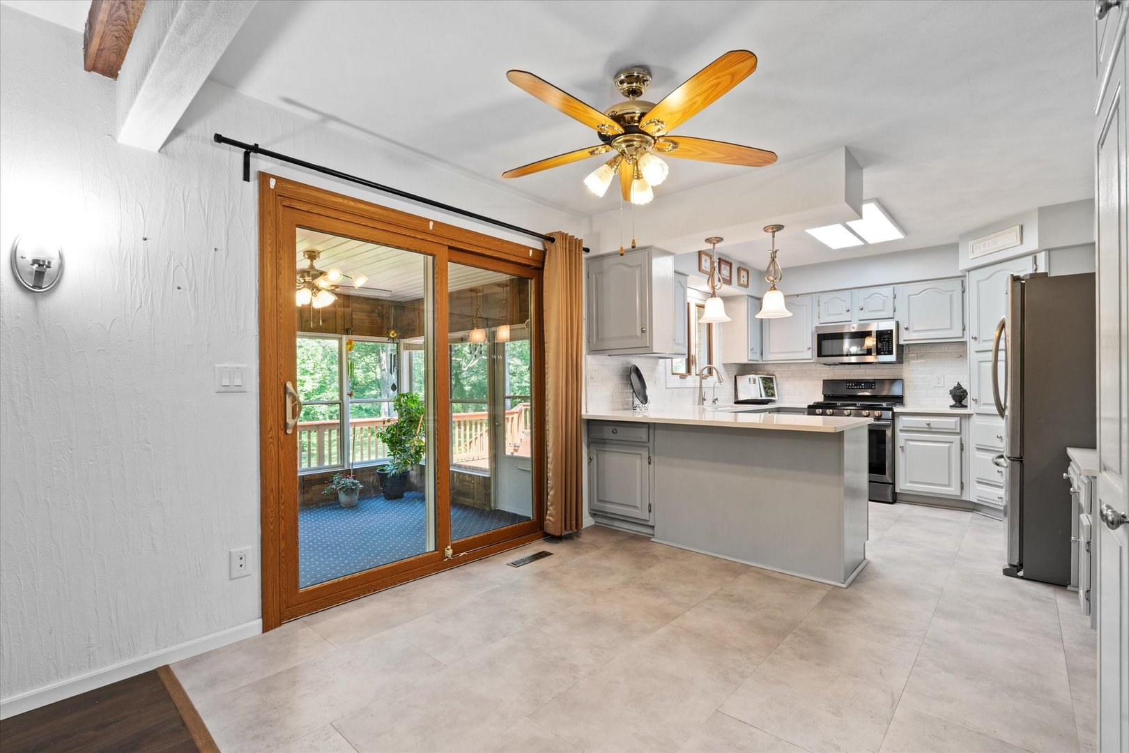 10 Oak Grove Road Geneseo, IL 61254 - Photo 13 of 43 a kitchen with stainless steel appliances a refrigerator a stove a sink and a view of living room